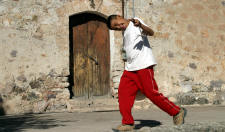 A young boy makes a face as he runs past the Alamos Cathedral...Bill Bell Photograph