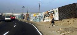 The wall between Mexico and the United States along the highway that leads you down the Baja is a stark contrast to the beauty a few kilometers ahead. Dot Bell Photograph