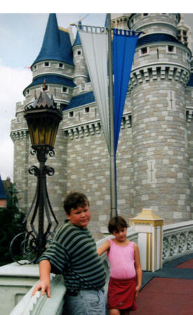 AdamCaddell and dylan Bell outside of the Magic Kingdom The World of Disney Photographs - Disneyworld, Paramount Studios and Epoch Centre by Bill And Dot Bell