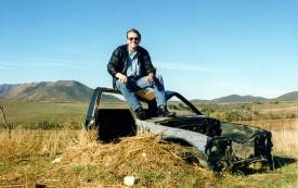 Bill Bell sits on wreckage in the Baja