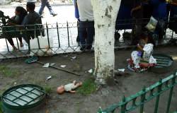 Young girl plays while her parents work selling their wares.  Bill Bell Photograph