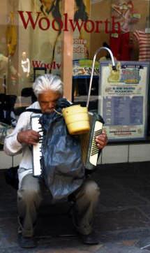 Blind musician plays for money on one of the many pedestrian freindly streets. Bill Bell Photography