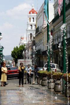 Fountains of water spout from the streets of Puebla.  Bill Bell photography